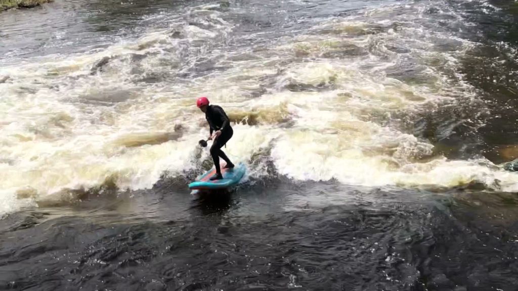 Rich Tucciarone SUP surfing the A wave of the Yampa river in Steamboat Springs, CO