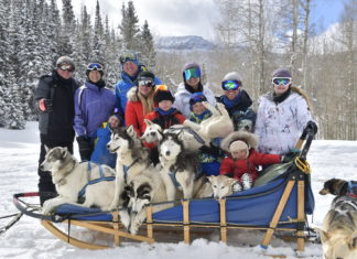 Change it Up with a Dog Sled Tour Snow Buddy Dog Sled Tours dog sled with family and cute dogs