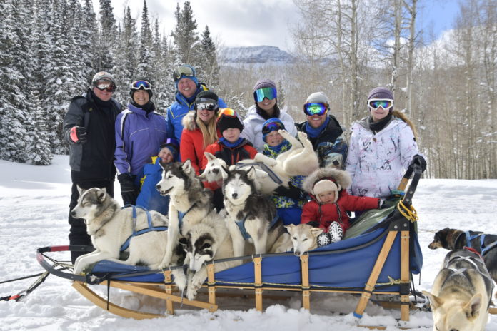 Snow Buddy Dog Sled Tours dog sled with family and cute dogs