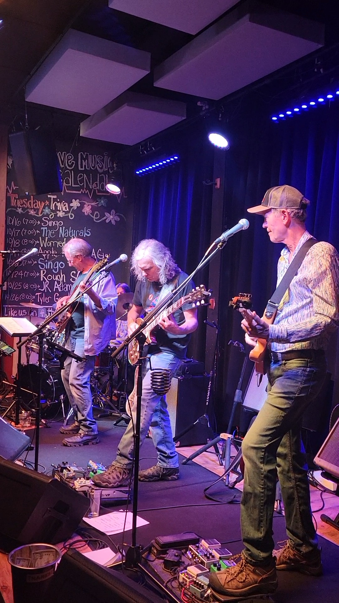 Photo of "Worried Men" preforming on stage.